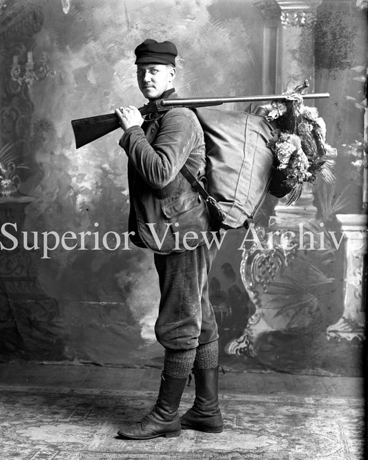 Hunter with Grouse on Gun
